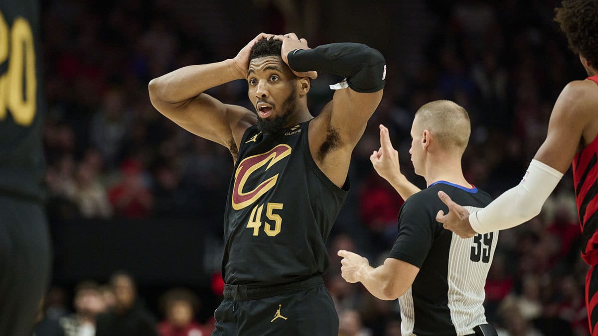 Cleveland Cavaliers guard Donovan Mitchell (45) reacts to a three point play by teammate guard Max Strus (1) during the second half against the Portland Trail Blazers at Moda Center.