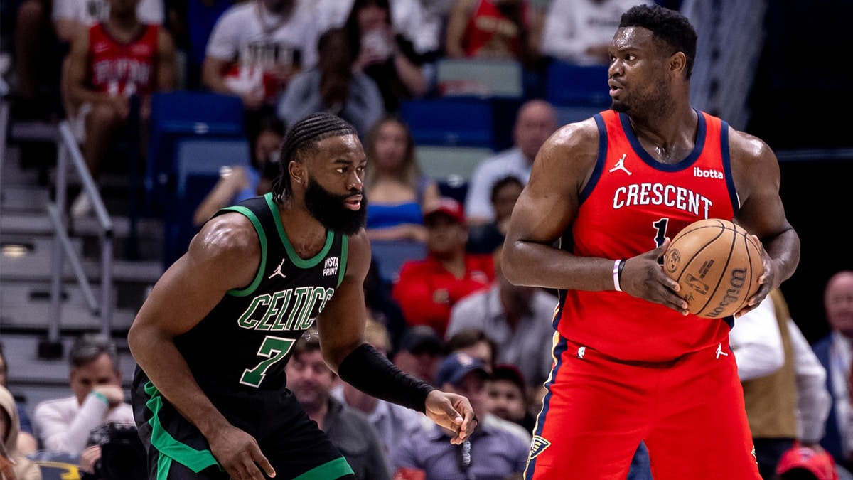 New Orleans Pelicans forward Zion Williamson (1) looks to pass the ball against Boston Celtics guard Jaylen Brown (7) during the first half at Smoothie King Center