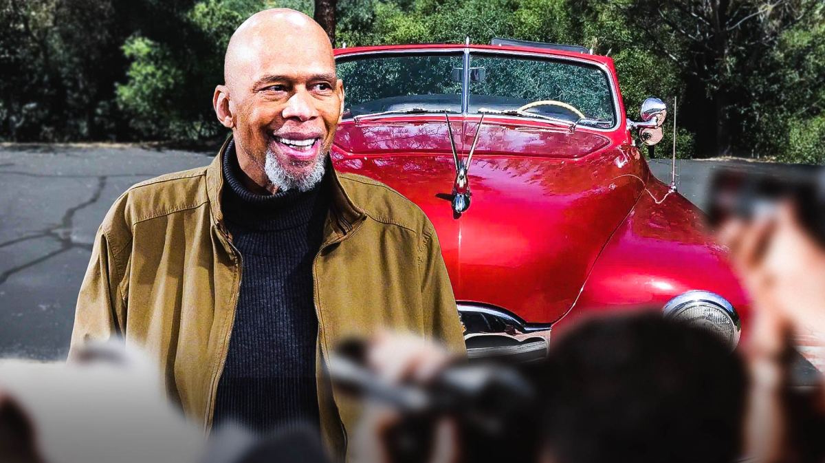 Kareem Abdul-Jabbar in front of a car he recently sold at auction.