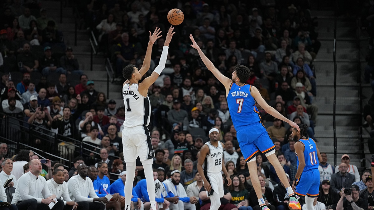 San Antonio Spurs center Victor Wembanyama (1) shoots over Oklahoma City Thunder forward Chet Holmgren (7) in the second half at Frost Bank Center.