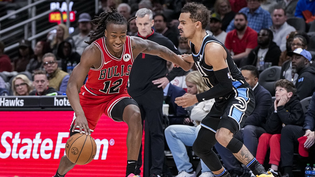 Chicago Bulls guard Ayo Dosunmu (12) dribbles against Atlanta Hawks guard Trae Young (11) during the second half at State Farm Arena. 
