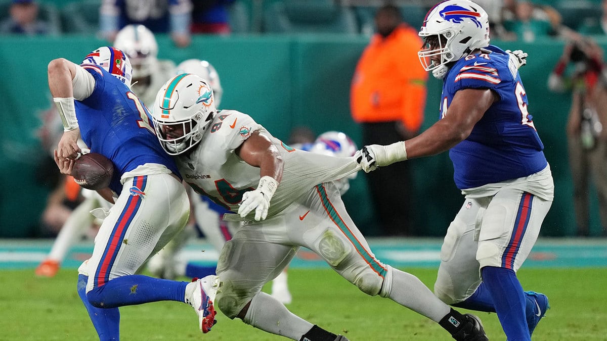  Miami Dolphins defensive tackle Christian Wilkins (94) strips the ball from Buffalo Bills quarterback Josh Allen (17) as guard O'Cyrus Torrence (64) defends on the play during the second half at Hard Rock Stadium.