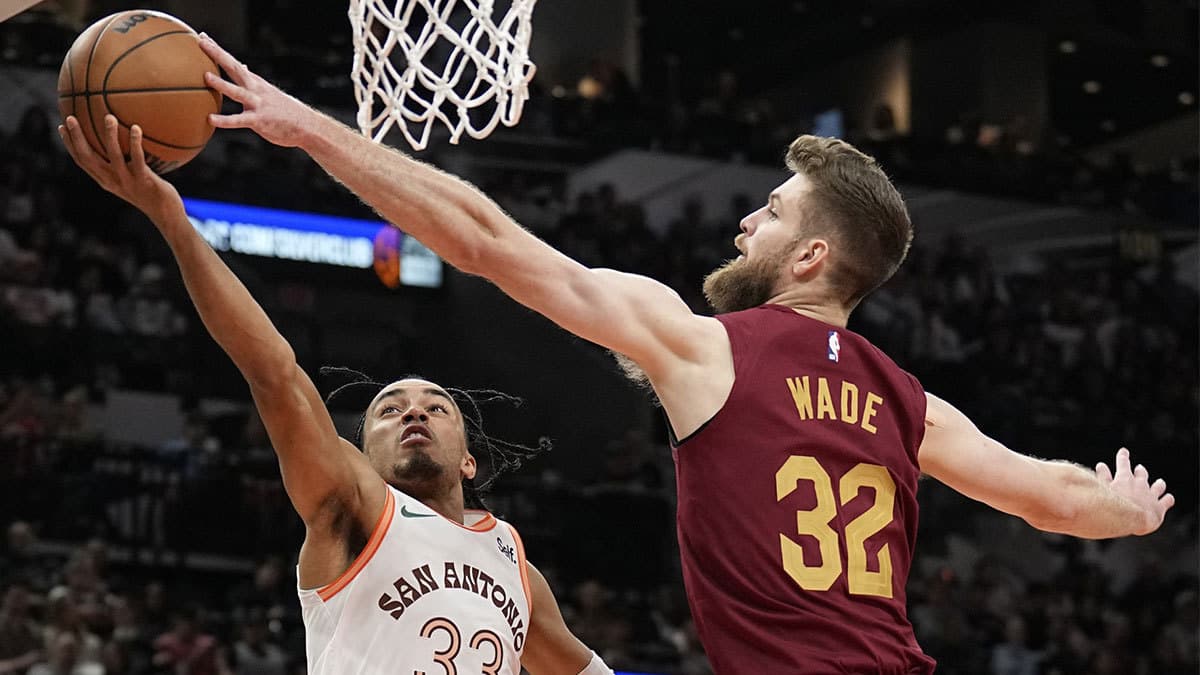 Cleveland Cavaliers forward Dean Wade (32) blocks the shot attempted by San Antonio Spurs 33 guard Tre Jones (33) during the first half at Frost Bank Center. 