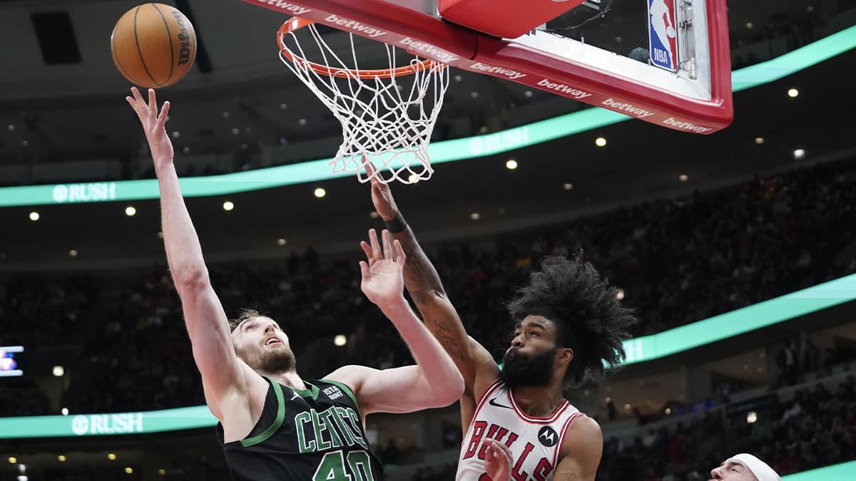 Chicago Bulls guard Coby White (0) defends Boston Celtics center Luke Kornet (40) during the second half at United Center.