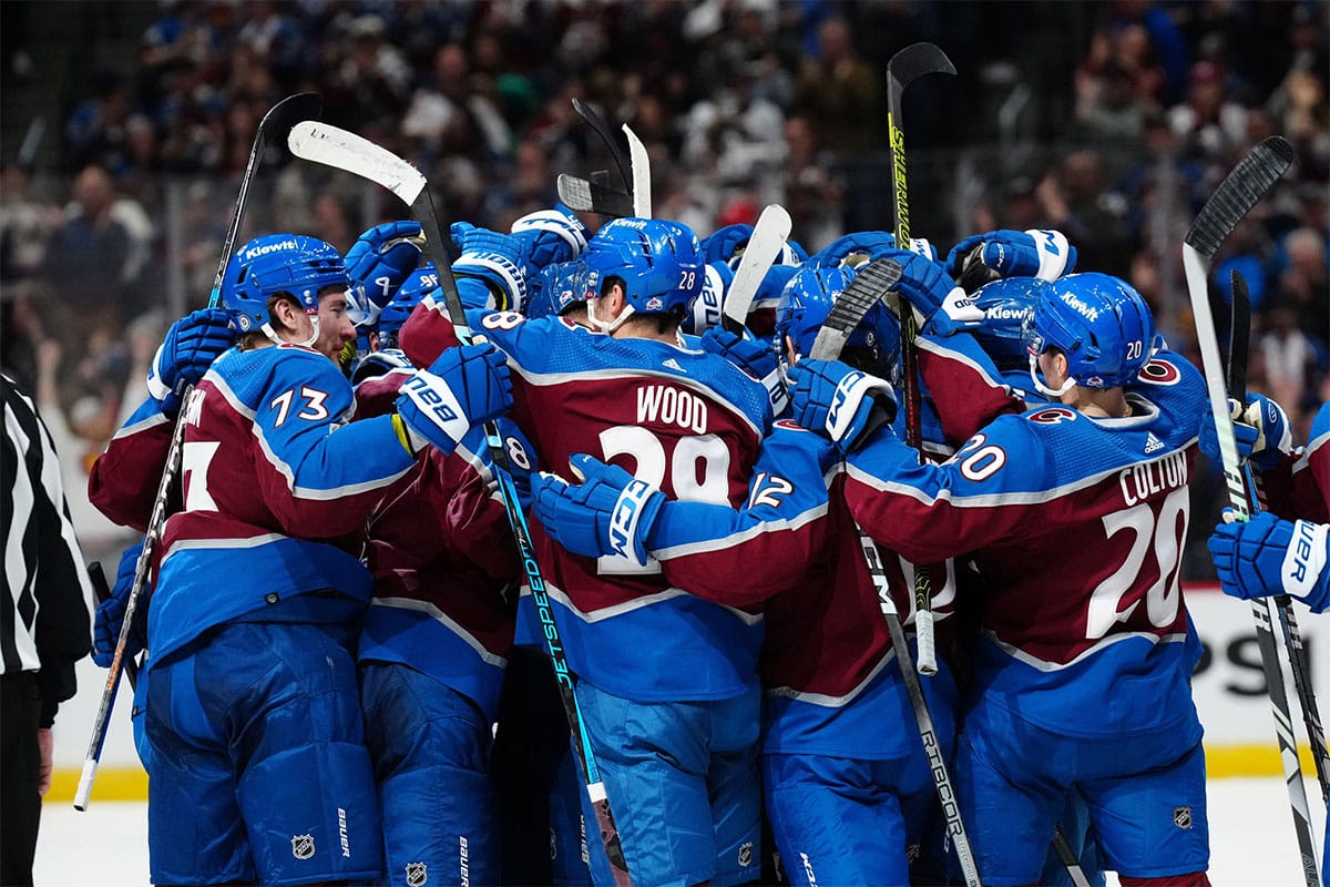 Members of the Colorado Avalanche celebrate an overtime win against the Pittsburgh Penguins at Ball Arena.