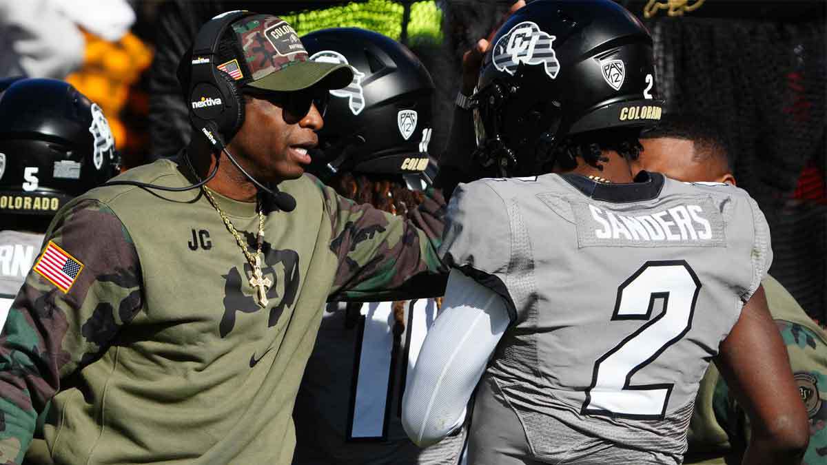 Colorado Buffaloes quarterback Shedeur Sanders (2) celebrates his touchdown with head coach Deion Sanders in the first half against the Arizona Wildcats at Folsom Field