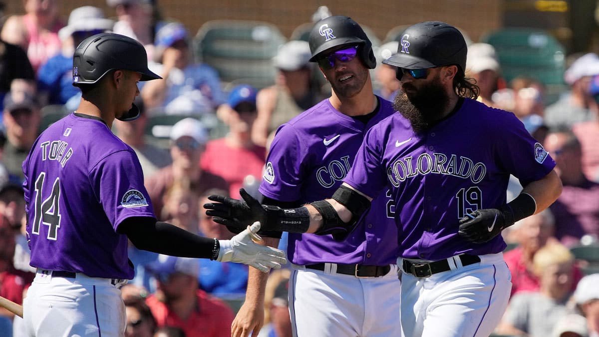 Colorado Rockies designated hitter Charlie Blackmon (19) celebrates with shortstop Ezequiel Tovar (14) and catcher Jacob Stallings (25) after hitting a two run home run against the Chicago Cubs in the third inning at Salt River Fields at Talking Stick