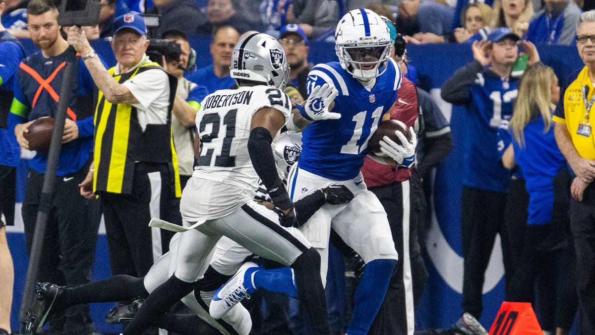 Indianapolis Colts wide receiver Michael Pittman Jr. (11) runs the ball after a catch wheel Las Vegas Raiders cornerback Amik Robertson (21) defends in the first half at Lucas Oil Stadium.