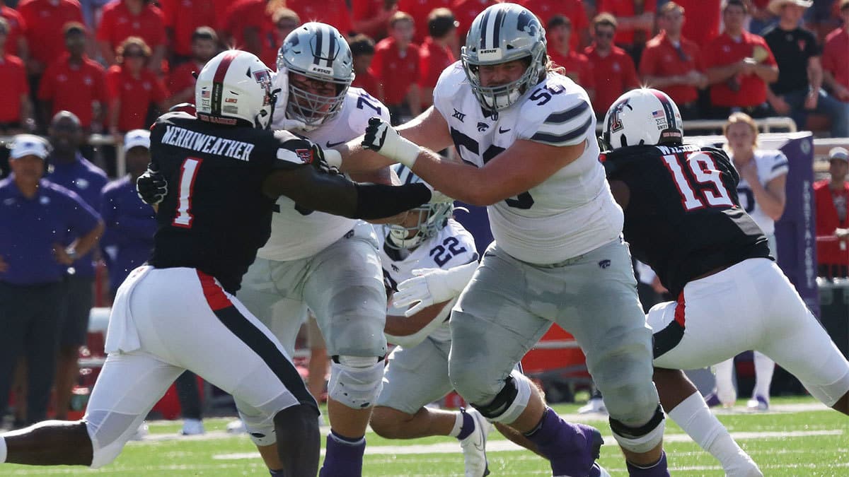 Kansas State Wildcats offensive tackle Cooper Beebe (50) blocks Texas Tech Red Raiders defensive linebacker Krishon Merriweather (1) in the first half at Jones AT&T Stadium