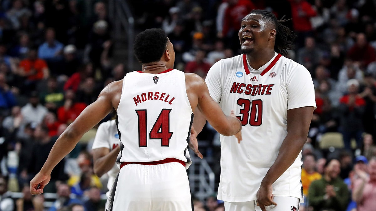 North Carolina State Wolfpack guard Casey Morsell (14) celebrates with forward DJ Burns Jr. (30) after beating the Oakland Golden Grizzlies in the second round of the 2024 NCAA Tournament at PPG Paints Arena.