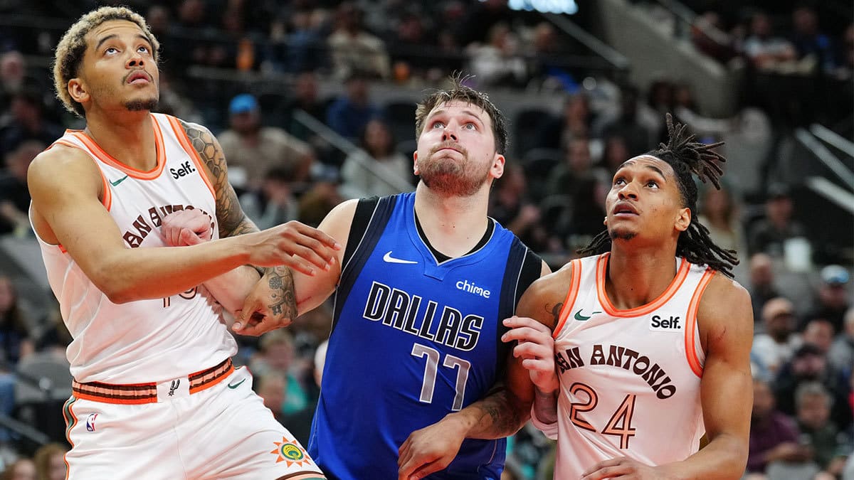Dallas Mavericks guard Luka Doncic (77) battles for position with San Antonio Spurs forward Jeremy Sochan (10) and guard Devin Vassell (24) in the second half at Frost Bank Center. 