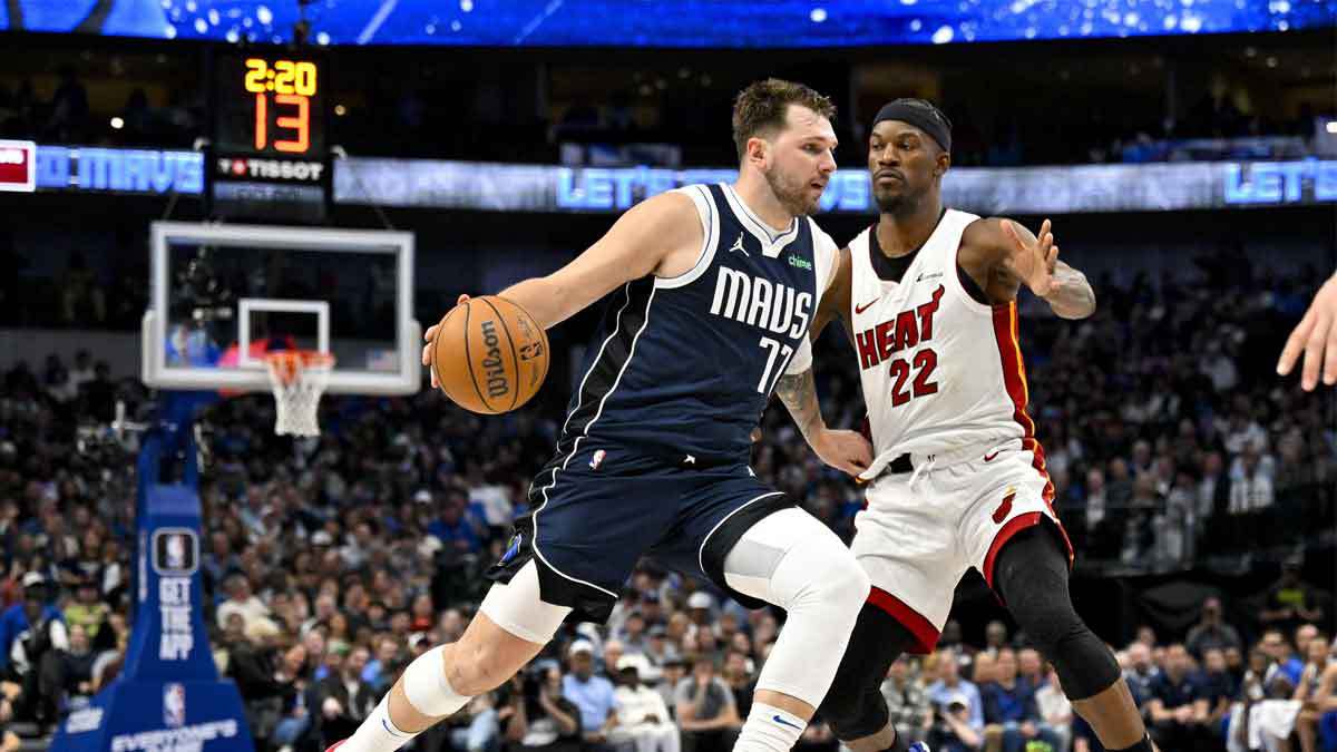  Dallas Mavericks guard Luka Doncic (77) looks the ball past Miami Heat forward Jimmy Butler (22) during the second half at the American Airlines
