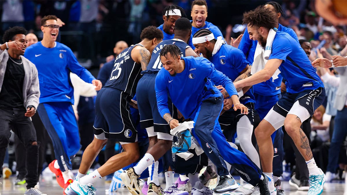 Dallas Mavericks players celebrate after the win against the Denver Nuggets at American Airlines Center