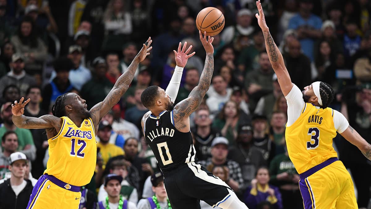  Milwaukee Bucks guard Damian Lillard (0) puts up a shot in the first overtime against Los Angeles Lakers forward Taurean Prince (12) and Los Angeles Lakers forward Anthony Davis (3) at Fiserv Forum