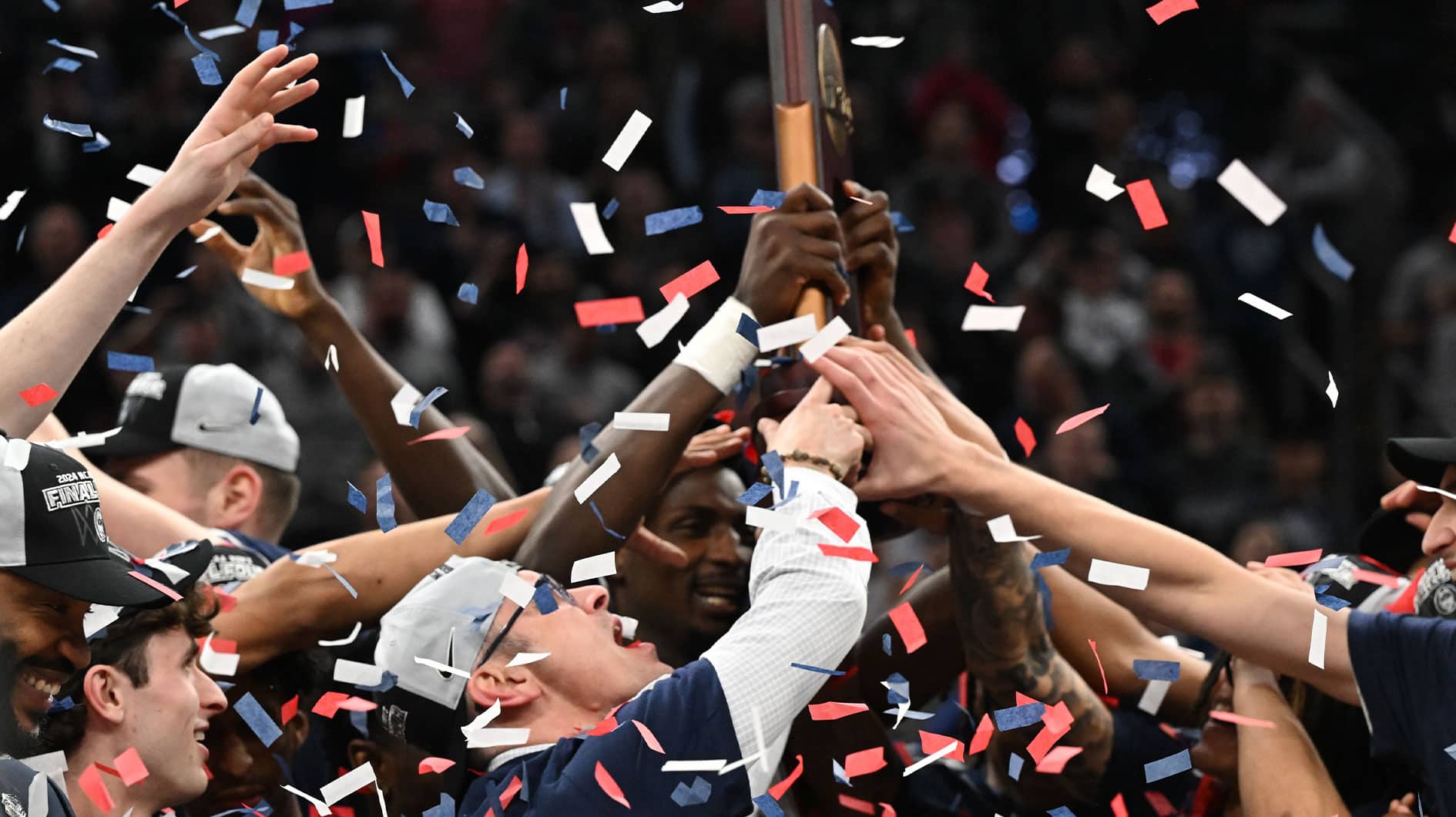 Connecticut Huskies head coach Dan Hurley reacts with the trophy in the finals of the East Regional of the 2024 NCAA Tournament against the Illinois Fighting Illini at TD Garden.
