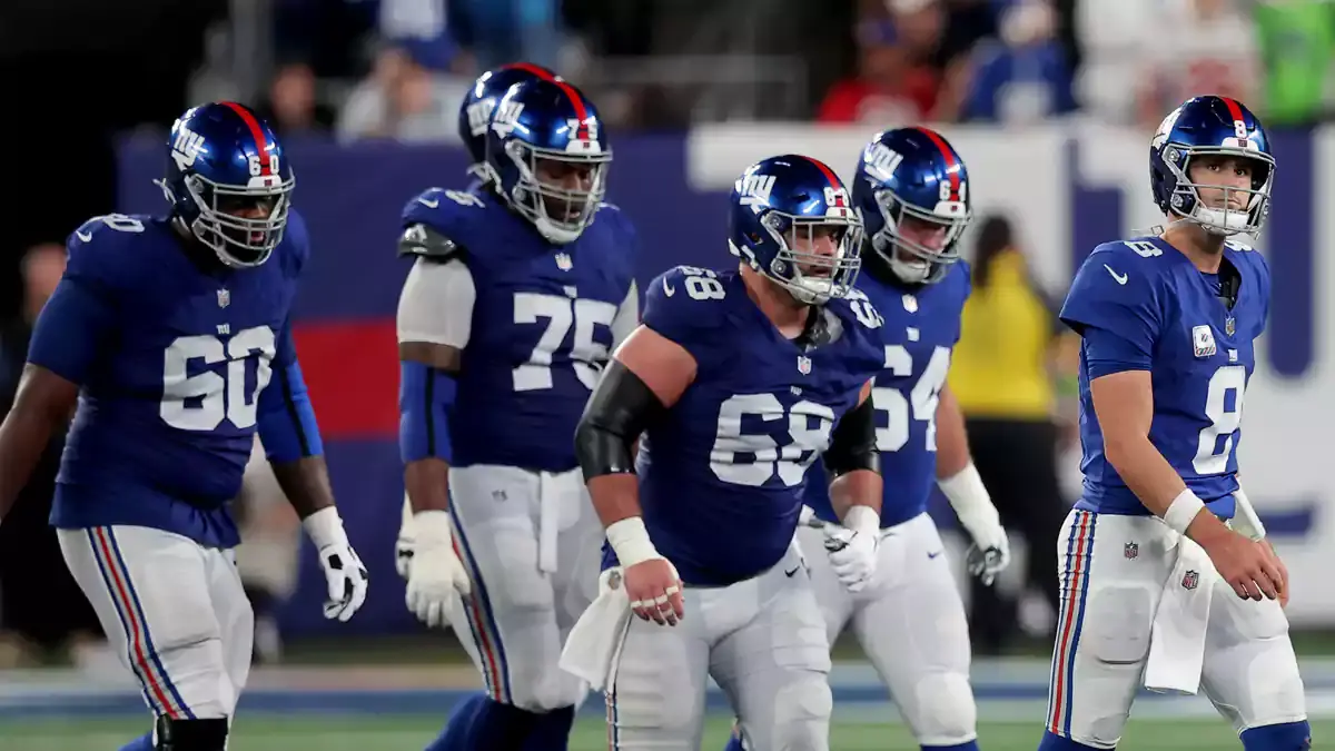 New York Giants quarterback Daniel Jones (8) walks off the field with guards Marcus McKethan (60) and Joshua Ezeudu (75) and Ben Bredeson (68) and Mark Glowinski (64) after being sacked during the fourth quarter against the Seattle Seahawks