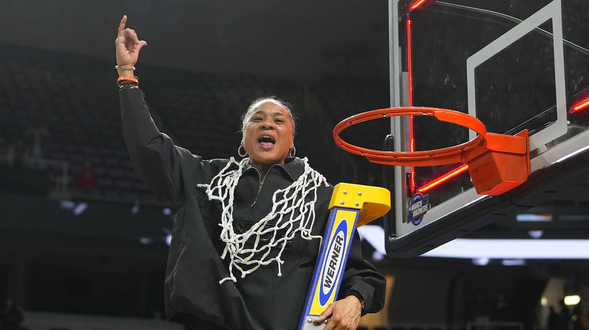 South Carolina Gamecocks head coach Dawn Staley celebrates cutting down the net after the game in the finals of the Albany Regional of the 2024 NCAA Tournament at MVP Arena.
