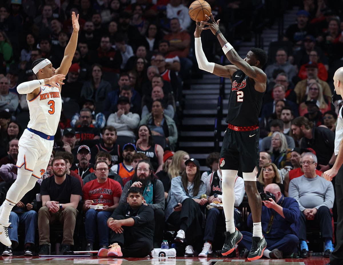 Portland Trail Blazers center Deandre Ayton (2) shoots a three-point shot over New York Knicks guard Josh Hart (3) in the third quarter at Moda Center. 