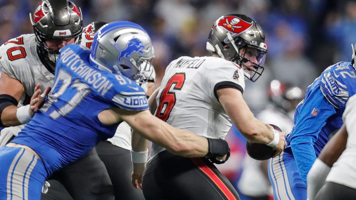 Detroit Lions defensive end Aidan Hutchinson (97) tackles Tampa Bay Buccaneers quarterback Baker Mayfield (6) during the second half of the NFC divisional round at Ford Field in Detroit on Sunday