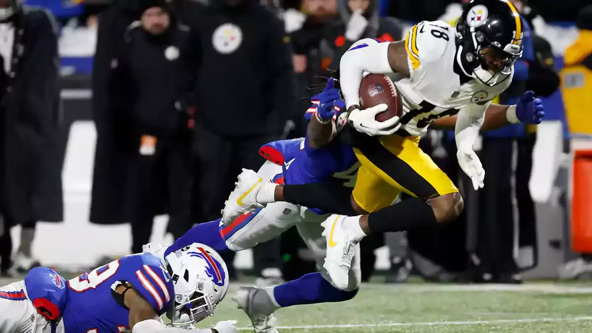 Pittsburgh Steelers wide receiver Diontae Johnson (18) is tackled after a catch.