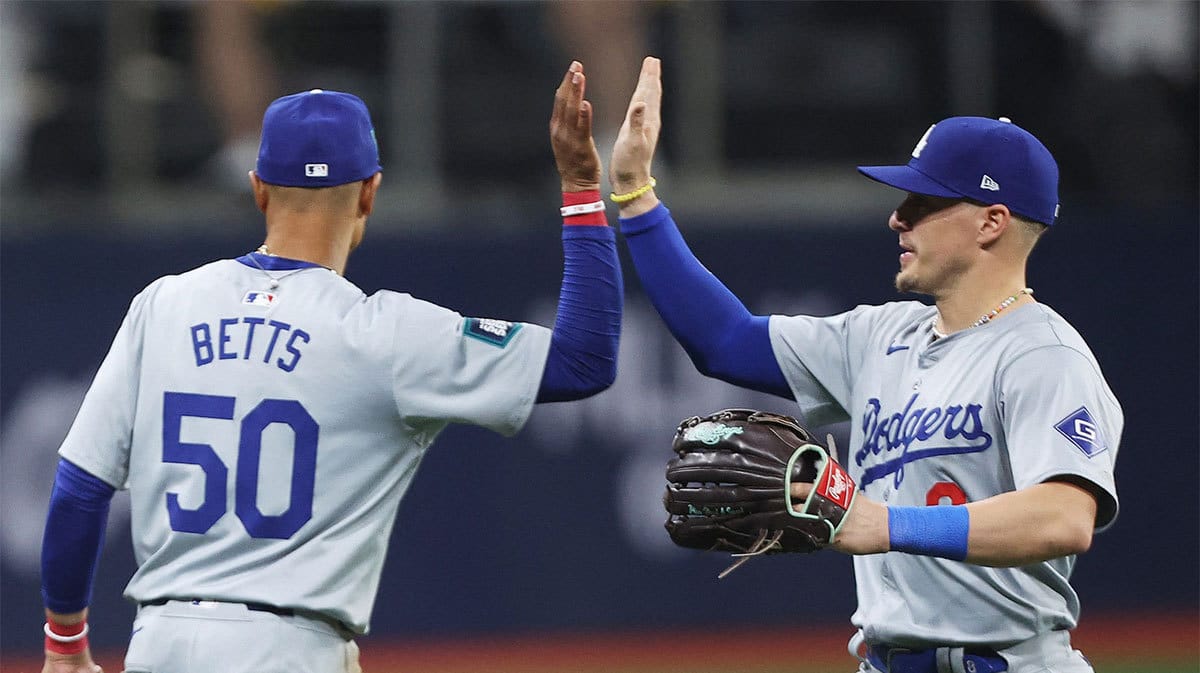 Los Angeles Dodgers players Mookie Betts and Enrique Hernandez celebrate after defeating the San Diego Padres during a MLB regular season Seoul Series game at Gocheok Sky Dome.