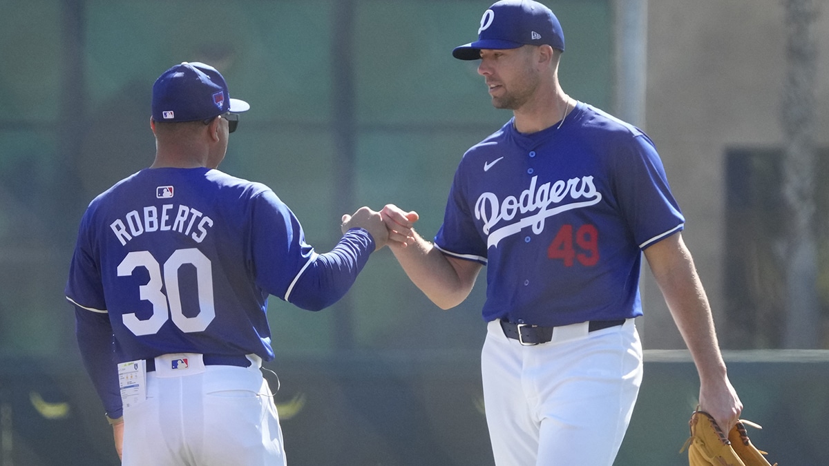 Los Angeles Dodgers relief pitcher Blake Treinen (49) talks to manager Dave Roberts during Spring Training camp at Camelback Ranch. 