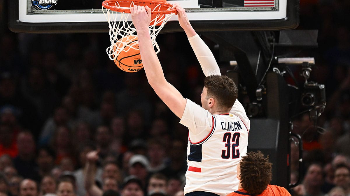 Connecticut Huskies center Donovan Clingan (32) dunks the ball against Illinois Fighting Illini forward Coleman Hawkins (33) in the finals of the East Regional of the 2024 NCAA Tournament at TD Garden