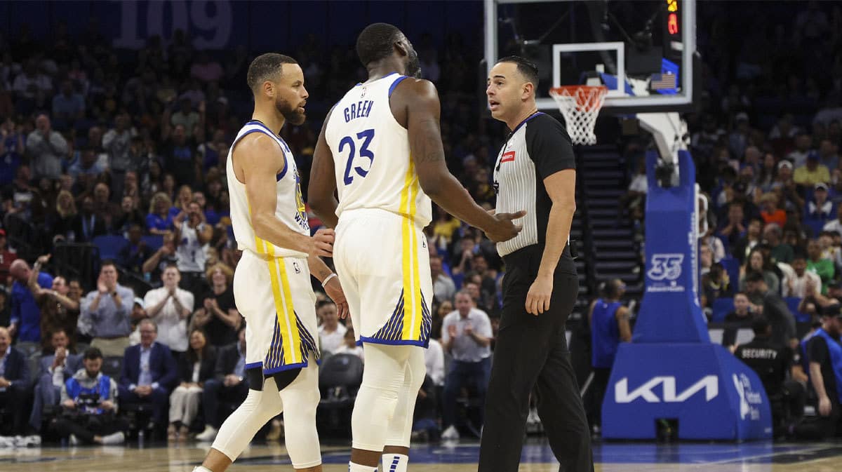 Golden State Warriors forward Draymond Green (23) talks to referee Ray Acosta (54) after receiving a foul in the first quarter at the Kia Center.