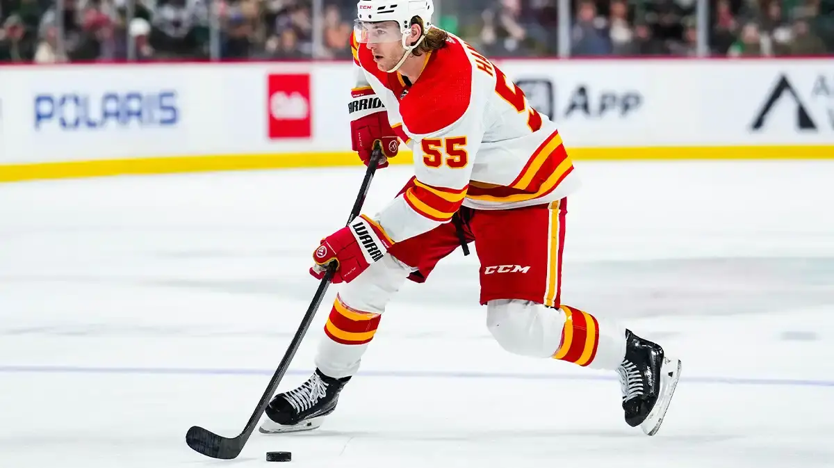 Calgary Flames defenseman Noah Hanifin (55) carries the puck during the third period against the Minnesota Wild at Xcel Energy Center.
