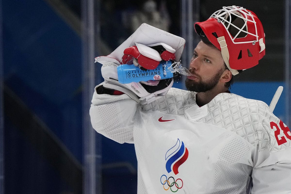 Team ROC goalkeeper Ivan Fedotov (28) takes a drink of water during a stoppage in play against Team Finland in the second period during the Beijing 2022 Olympic Winter Games at National Indoor Stadium.