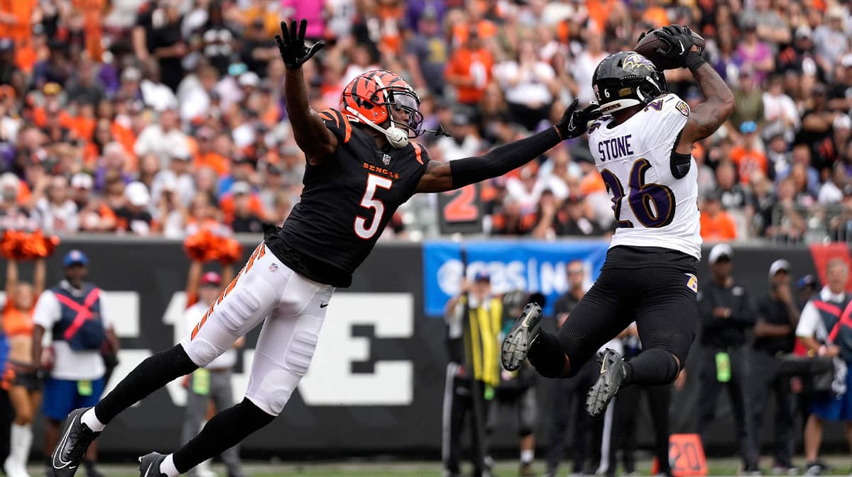 Baltimore Ravens safety Geno Stone (26) intercepts a pass intended for Cincinnati Bengals wide receiver Tee Higgins (5) in the third quarter of a Week 2 NFL football game between the Baltimore Ravens and the Cincinnati Bengals.