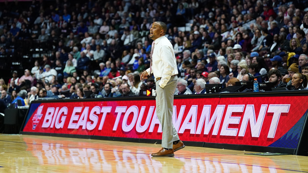 Georgetown Hoyas interim head coach Darnell Haney watches from the sideline as they take on the UConn Huskies 