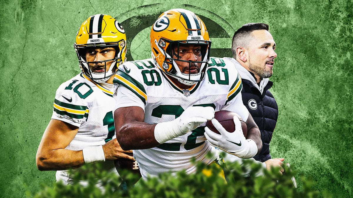 AJ Dillon in the middle, Coach Matt LaFleur and Jordan Love around him, and Green Bay Packers wallpaper in the background.
