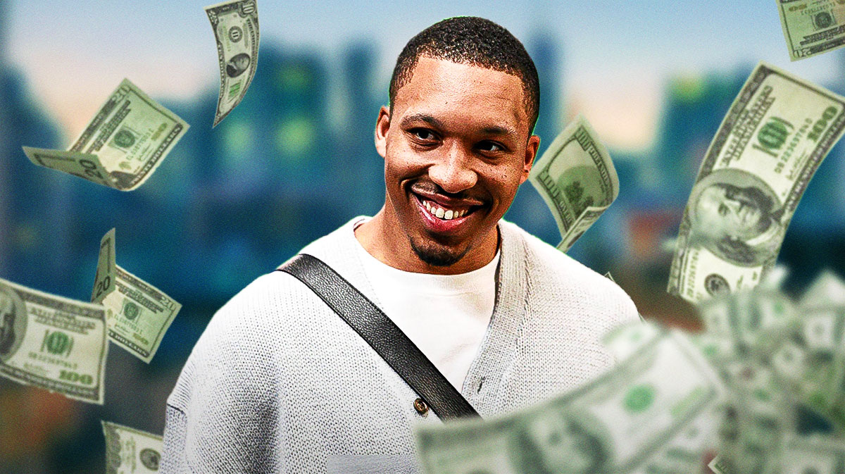 Grant Williams surrounded by piles of cash.