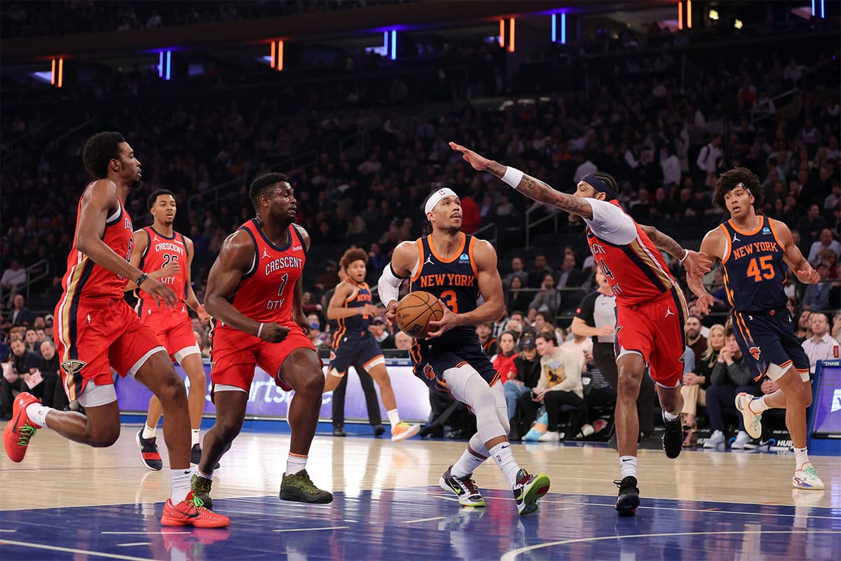 New York Knicks guard Josh Hart (3) drives to the basket against New Orleans Pelicans forward Herbert Jones (5) and guard Trey Murphy III (25) and forwards Zion Williamson (1) and Brandon Ingram (14) during the first quarter at Madison Square Garden. 