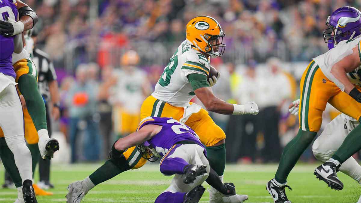 ; Green Bay Packers running back AJ Dillon (28) runs with the ball against the Minnesota Vikings in the third quarter at U.S. Bank Stadium