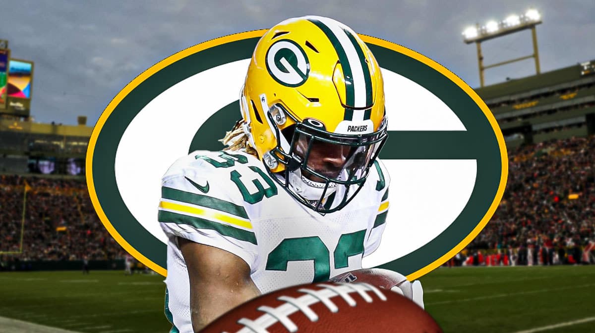 Packers Aaron Jones looking sad/upset next to a Packers logo at Lambeau Field