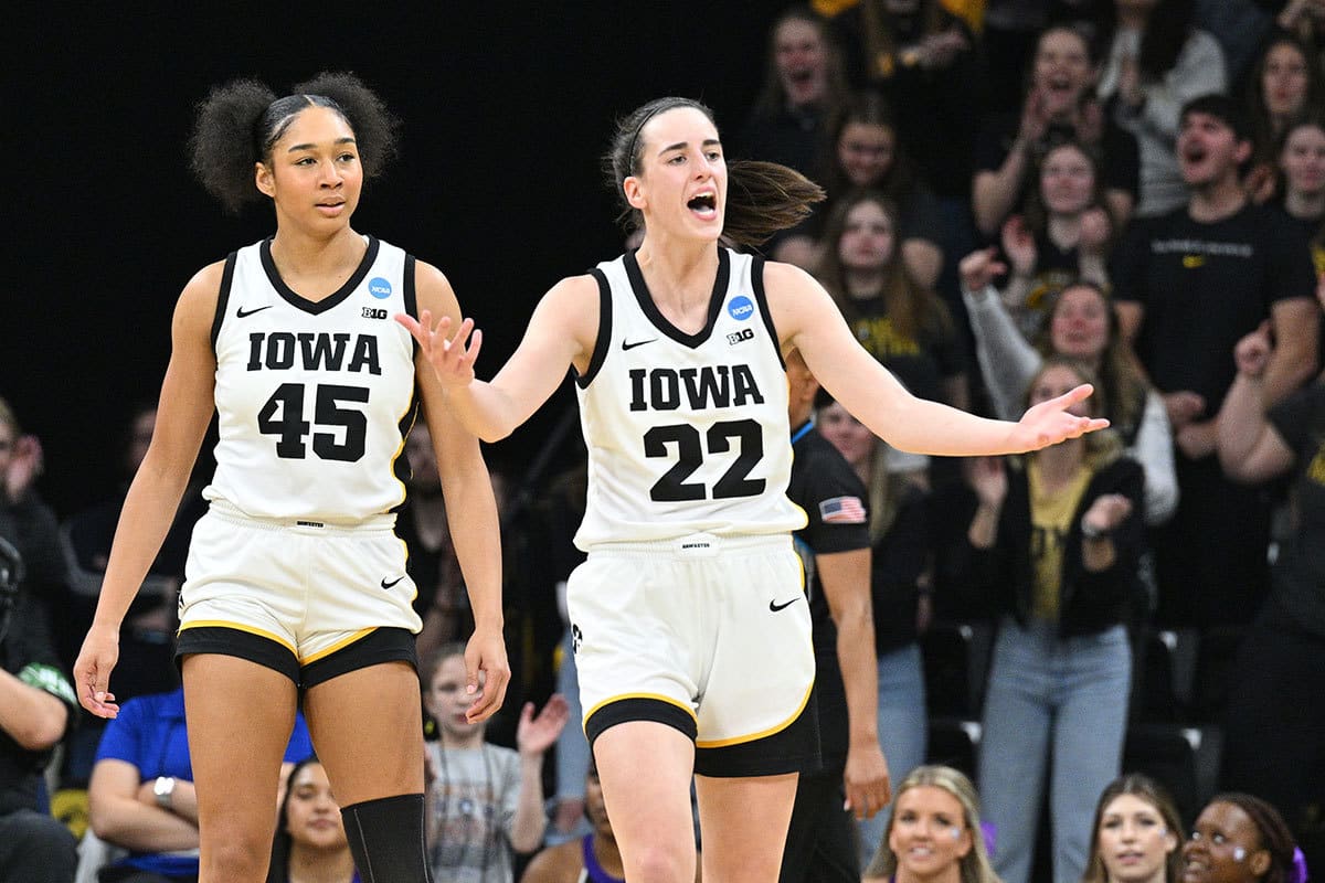 Iowa Hawkeyes guard Caitlin Clark (22) reacts as forward Hannah Stuelke (45) looks on during the second quarter of the NCAA first round game against the Holy Cross Crusaders at Carver-Hawkeye Arena.
