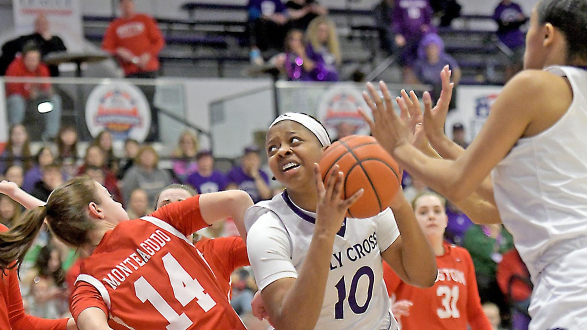 Holy Cross' Janelle Allen grabs a rebound from Boston University's Ines Monteagudo