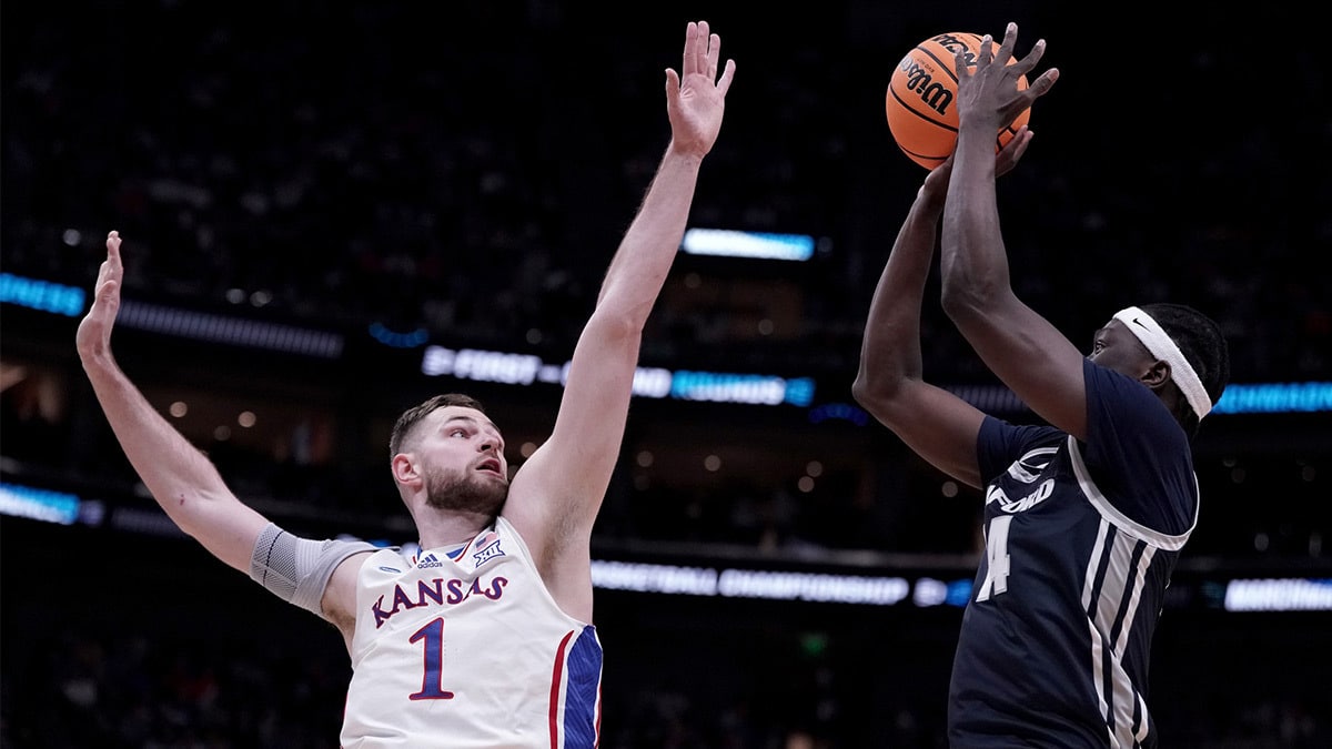 Samford Bulldogs forward Achor Achor (14) shoots against Kansas Jayhawks center Hunter Dickinson (1) during the first half in the first round of the 2024 NCAA Tournament at Vivint Smart Home Arena-Delta Center.