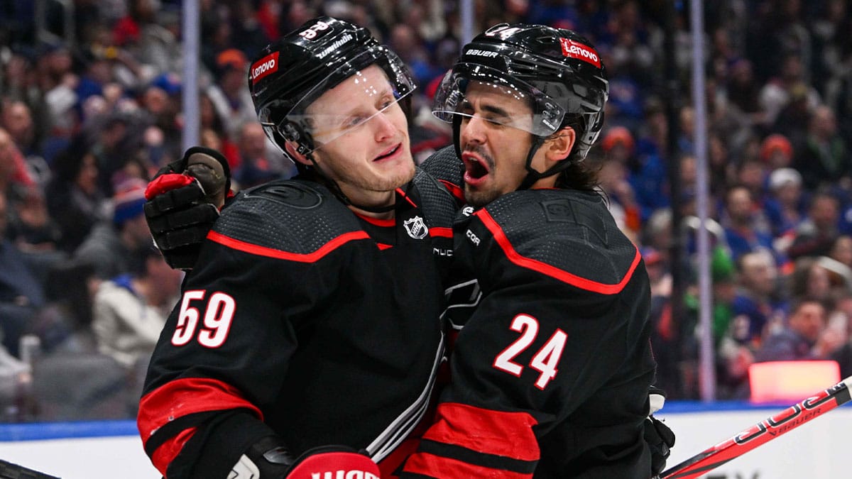 Carolina Hurricanes center Seth Jarvis (24) celebrates his second goal against the New York Islanders with Carolina Hurricanes left wing Jake Guentzel (59) during the first period at UBS Arena