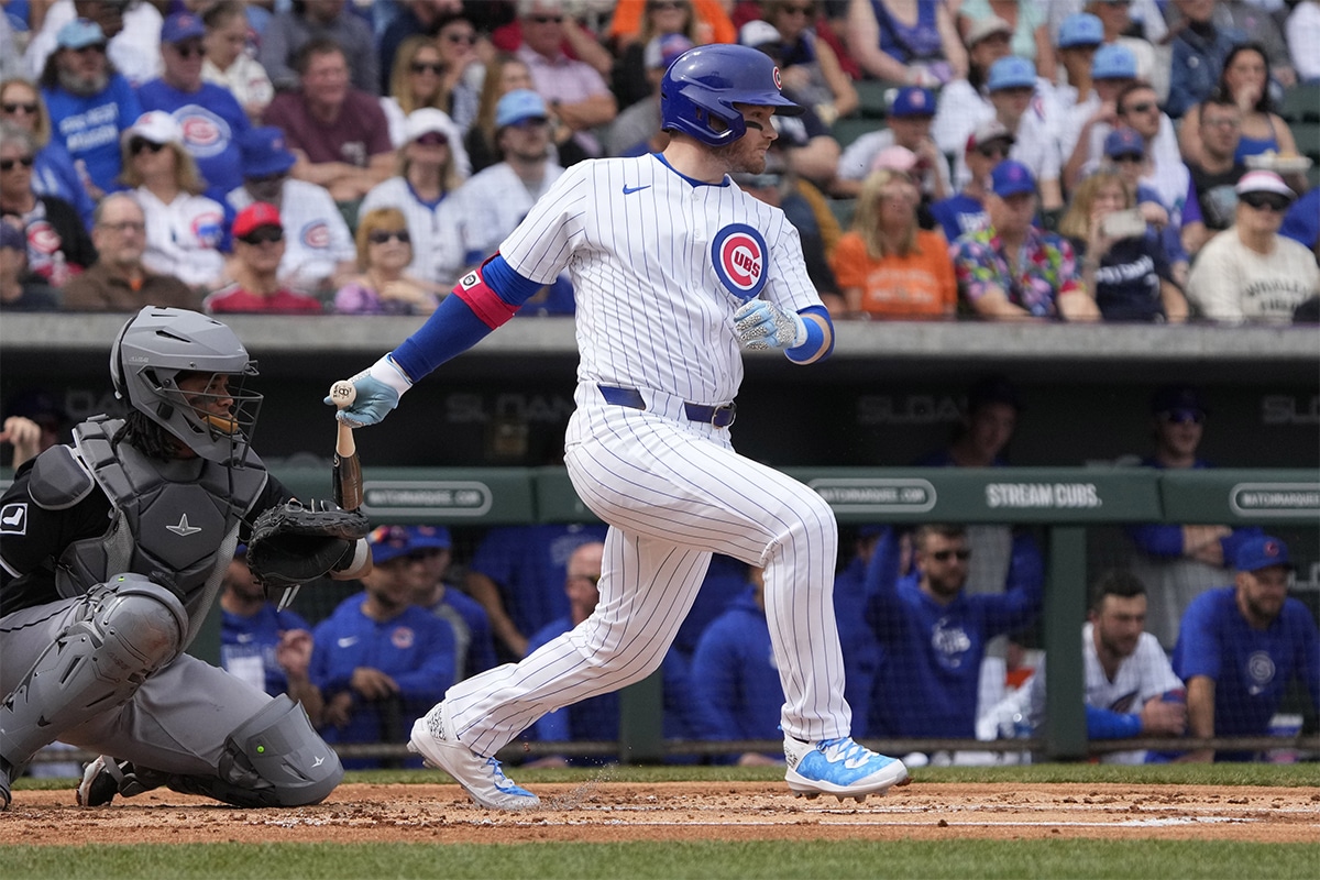 Chicago Cubs left fielder Ian Happ (8) hits a single against the Chicago White Sox in the first inning at Sloan Park.