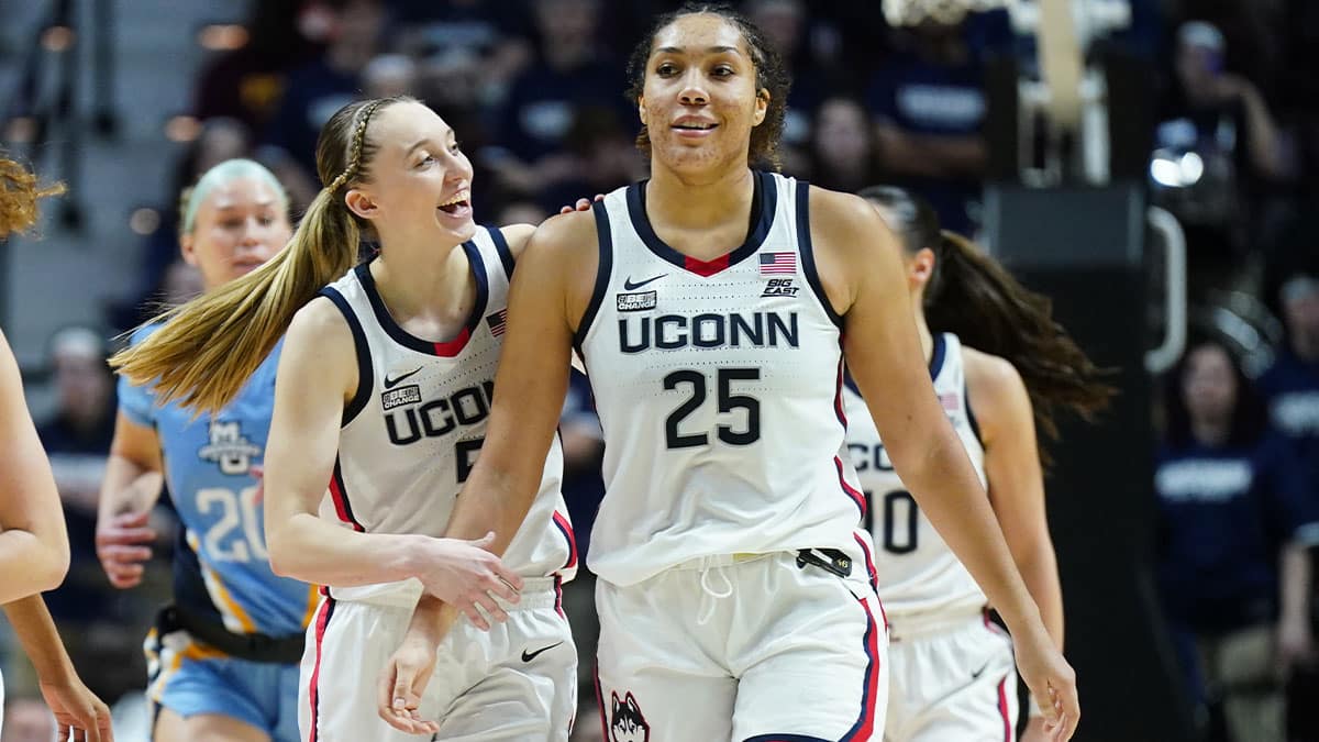 UConn Huskies guard Paige Bueckers (5) reacts with forward Ice Brady (25) after a play against the Marquette Golden Eagles in the second half at Mohegan Sun Arena.
