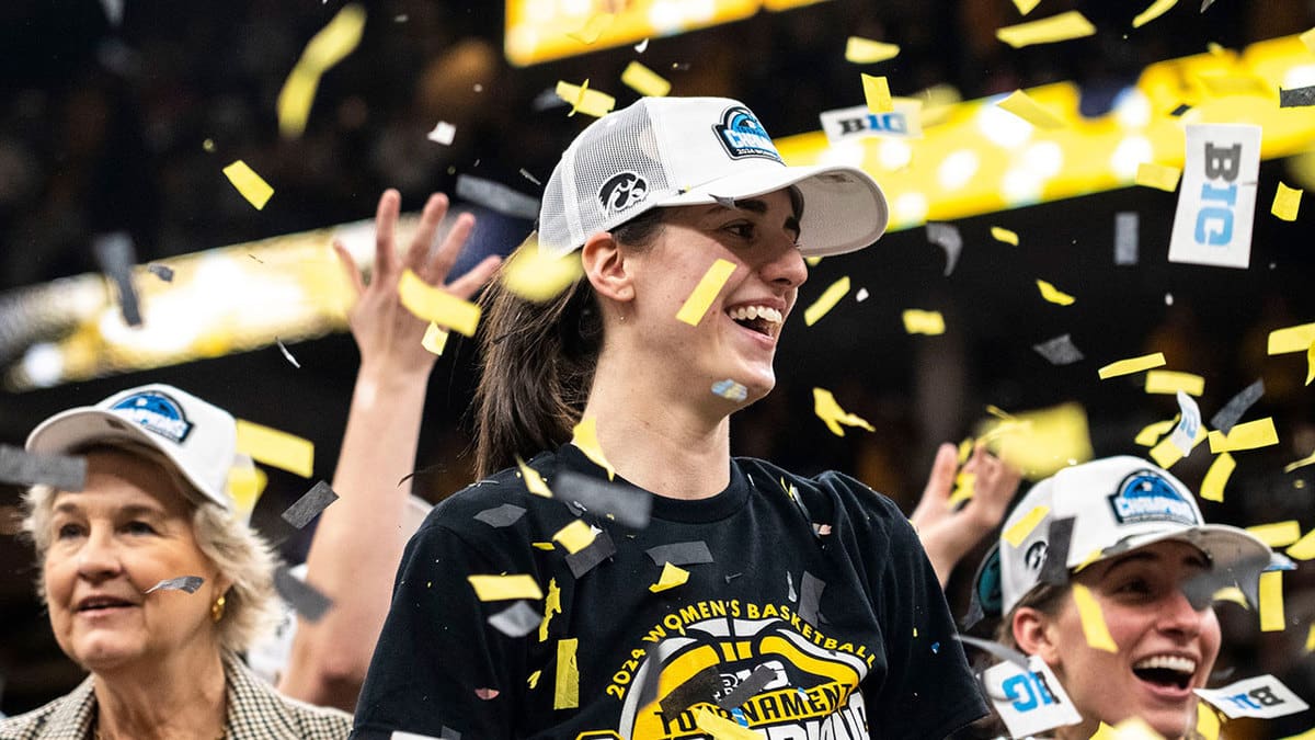 Iowa guard Caitlin Clark (22) reacts as confetti falls after Iowa wins the Big Ten Tournament championship game at the Target Center