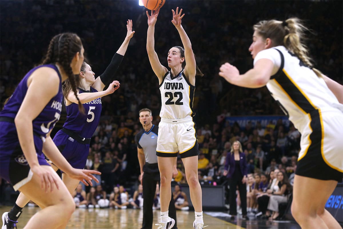 owa’s Caitlin Clark (22) shoots against Holy Cross in a first-round NCAA Tournament game 