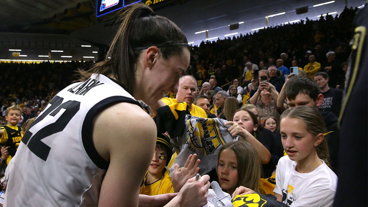 Iowa’s Caitlin Clark (22) signs autographs after defeating Holy Cross in a first-round NCAA Tournament gam