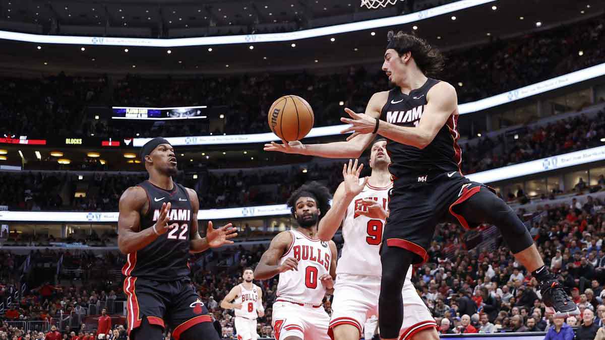 Miami Heat guard Jaime Jaquez Jr. (11) passes the ball to forward Jimmy Butler (22) against the Chicago Bulls during the second half at United Center.