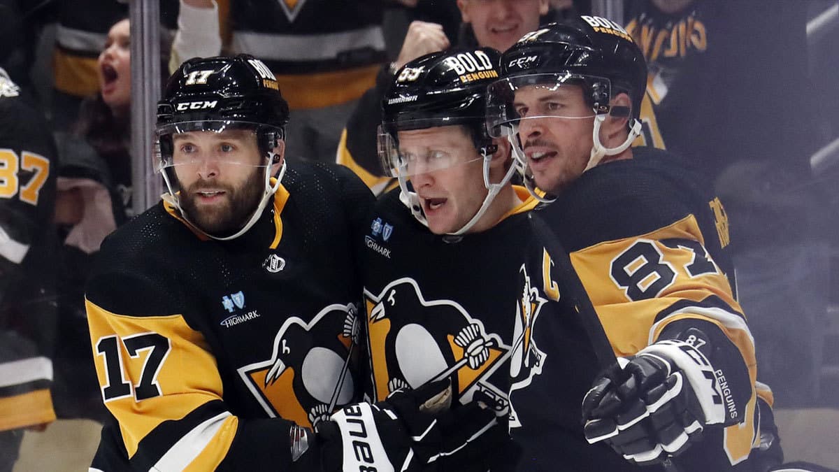 Penguins left wing Jake Guentzel (middle) celebrates with right wing Bryan Rust (17) and center Sidney Crosby (87) after Guentzel scored a goal against the Montreal Canadiens during the third period at PPG Paints Arena