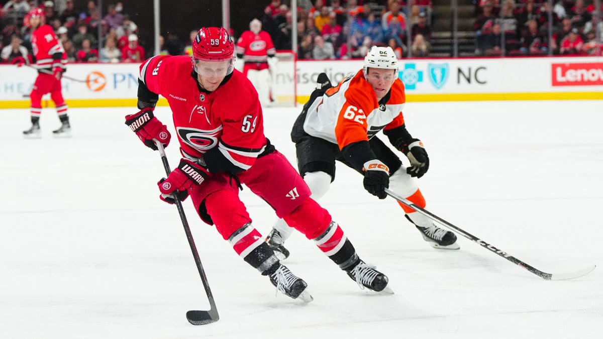 Carolina Hurricanes left wing Jake Guentzel (59) skates with the puck past Philadelphia Flyers right wing Olle Lycksell (62) during the first period at PNC Arena.