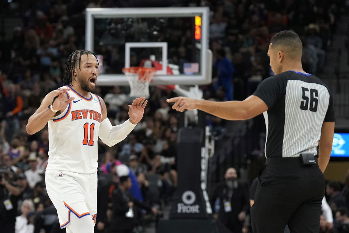 New York Knicks guard Jalen Brunson (11) reacts while speaking with official John Conley (56) during the second half against the San Antonio Spurs at Frost Bank Center.